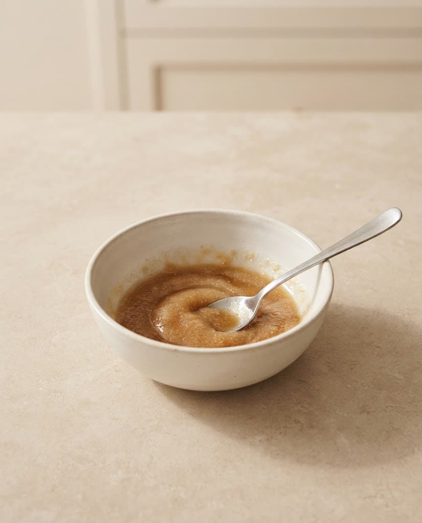 Melted butter, brown sugar, and granulated sugar mixed together in a small cream ceramic bowl